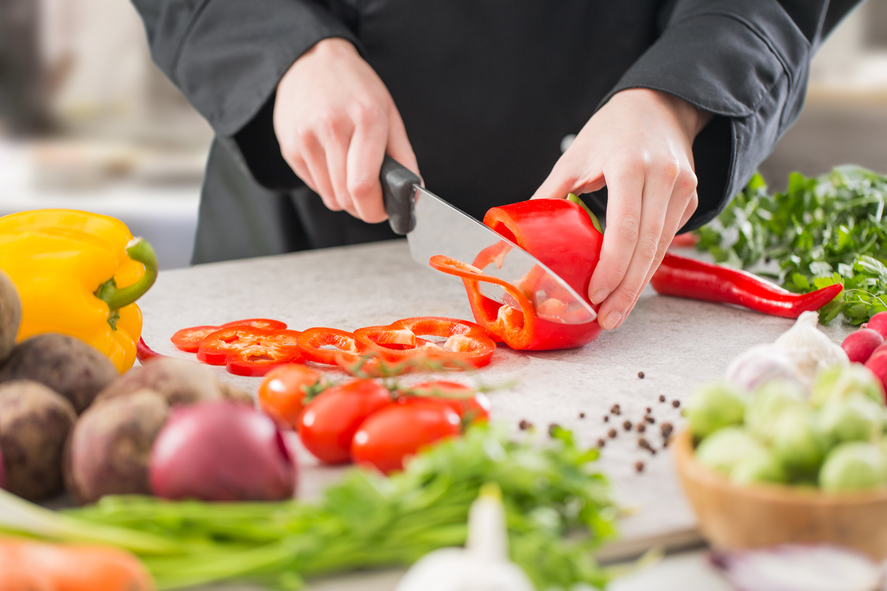 The chef slicing vegetables.